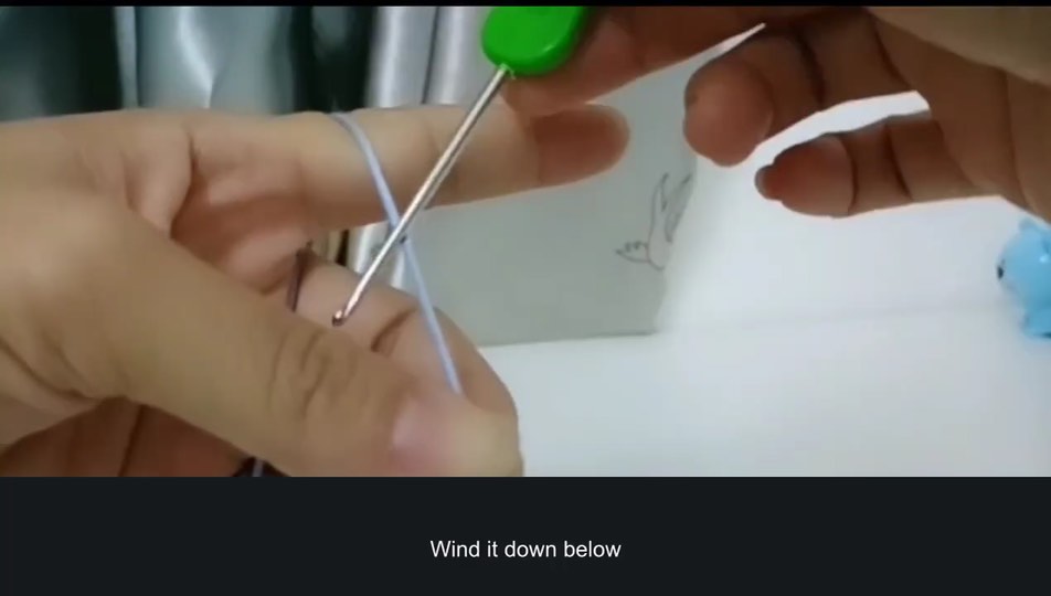 Holding yarn and hook before the first stitch — tutorial video frame